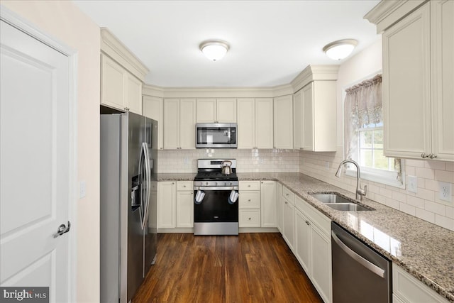 kitchen with sink, stainless steel appliances, dark hardwood / wood-style flooring, and tasteful backsplash