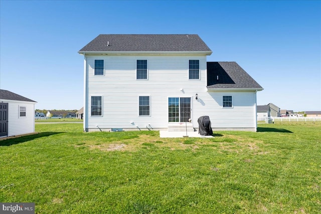 rear view of property with a patio and a yard