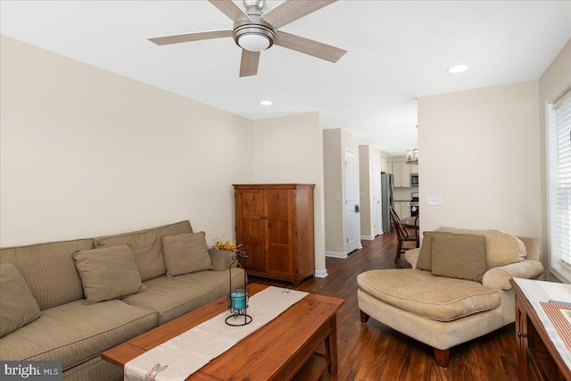 living room featuring dark hardwood / wood-style flooring and ceiling fan