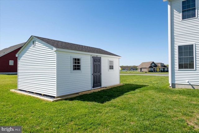 view of outdoor structure with a lawn