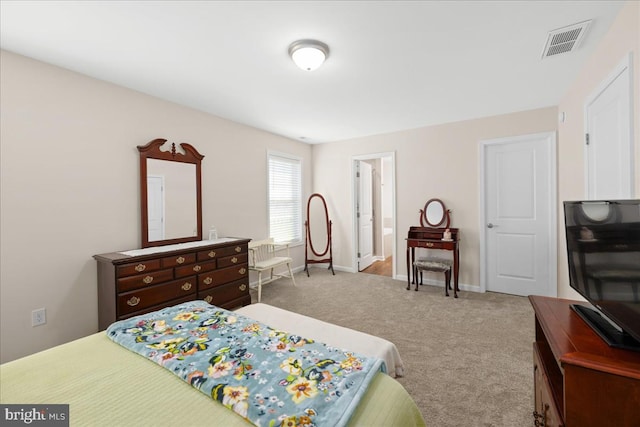 carpeted bedroom featuring ensuite bathroom