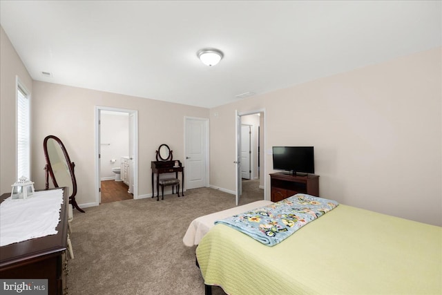 carpeted bedroom with ensuite bath