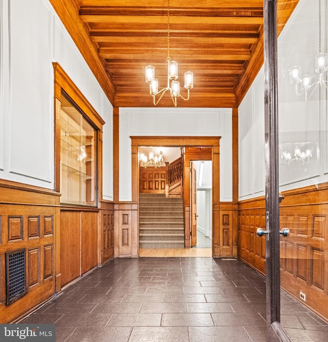 interior space featuring a notable chandelier, beam ceiling, french doors, and wood ceiling