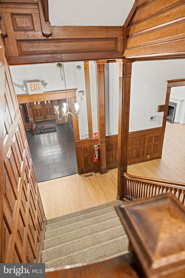 staircase with ornate columns and tile floors