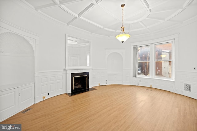 unfurnished living room featuring a premium fireplace, coffered ceiling, and light wood-type flooring