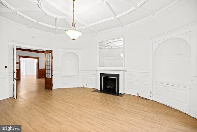 unfurnished living room with a high end fireplace, coffered ceiling, and light hardwood / wood-style flooring