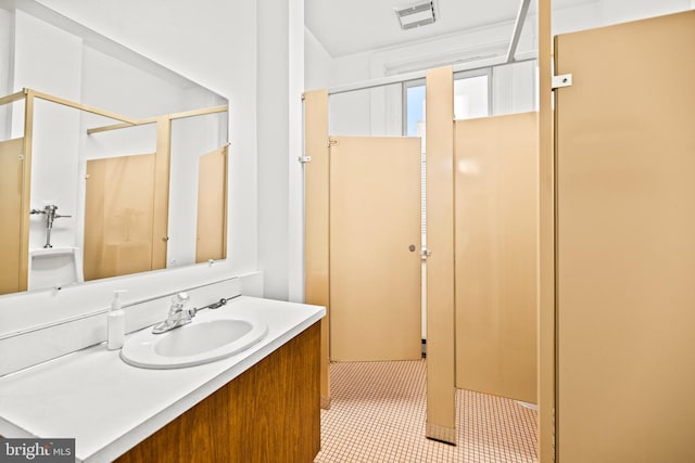 bathroom with tile floors and vanity