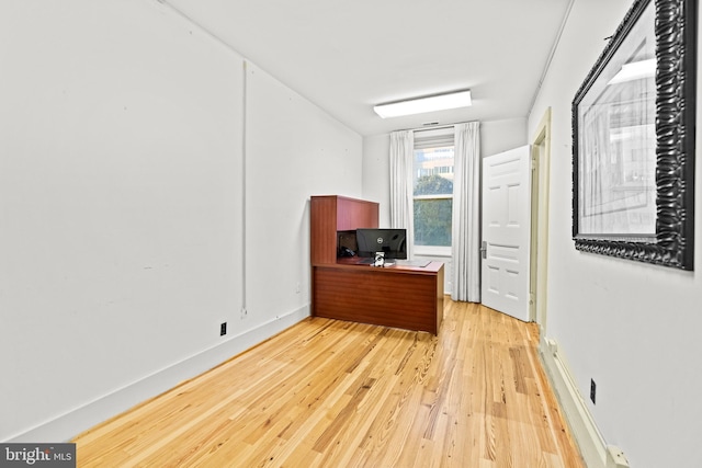 home office with wood-type flooring