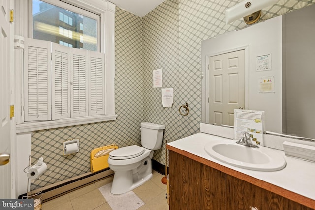 bathroom with baseboard heating, vanity, toilet, and tile floors