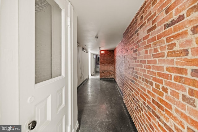 corridor featuring brick wall