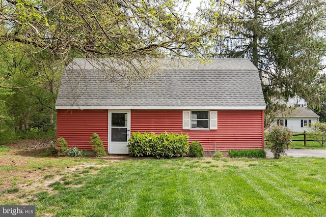 view of outbuilding with a lawn