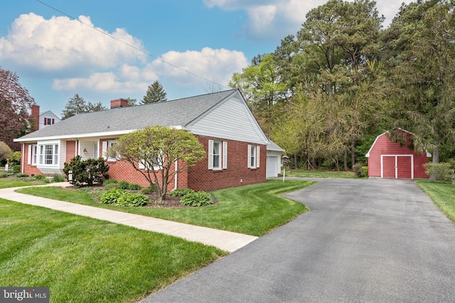 view of property exterior with a yard, an outdoor structure, and a garage