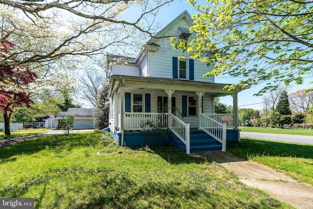 view of front of home featuring a front lawn, a garage, and a porch