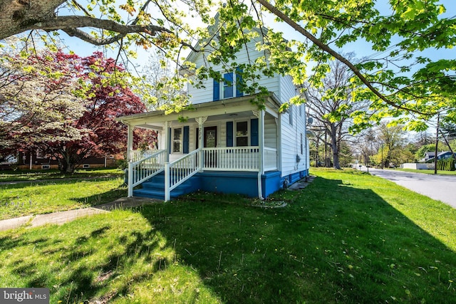 view of front of house featuring a front yard and a porch