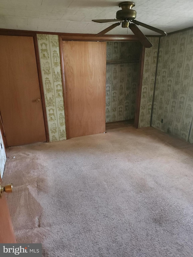 unfurnished bedroom with carpet and ceiling fan