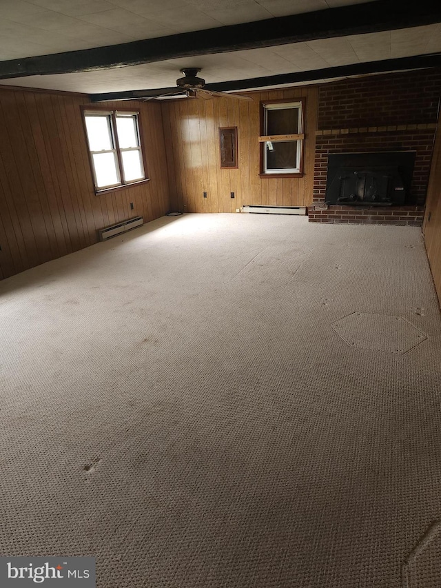 unfurnished living room with ceiling fan, carpet, a brick fireplace, beam ceiling, and baseboard heating