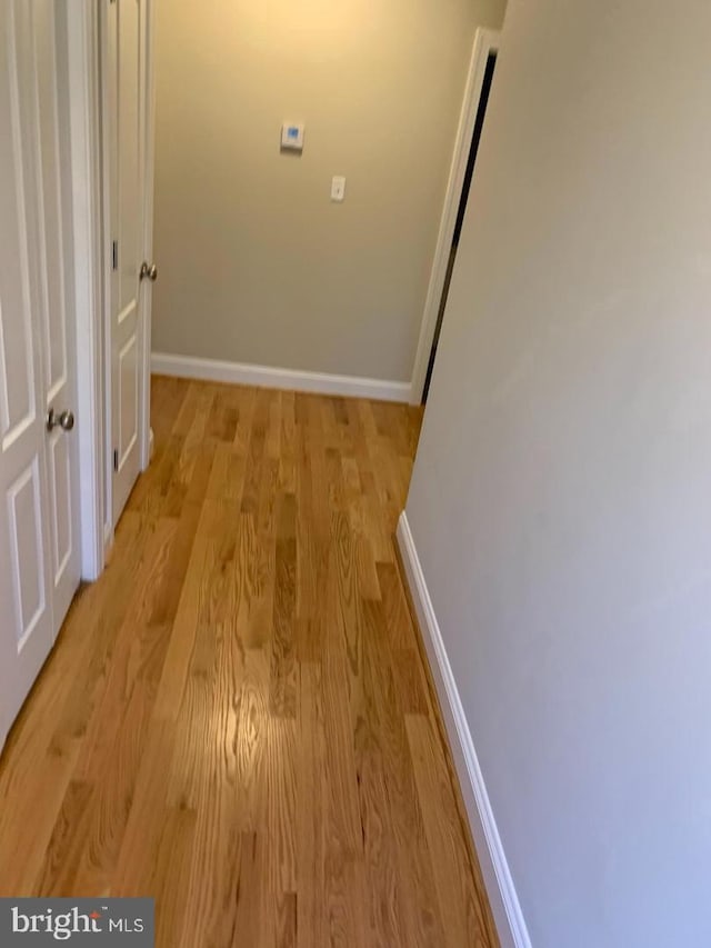 corridor with light hardwood / wood-style flooring