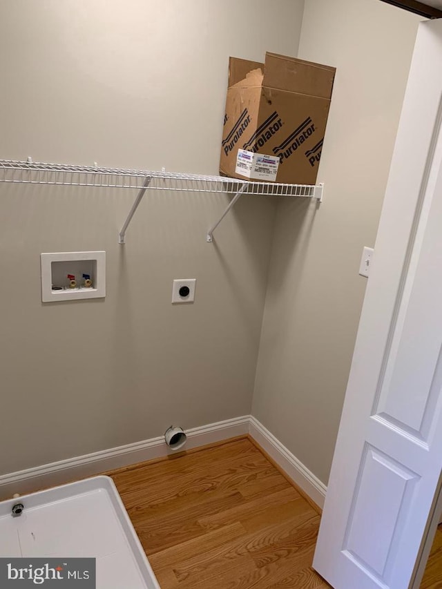 laundry area with hookup for a washing machine, light hardwood / wood-style flooring, and electric dryer hookup