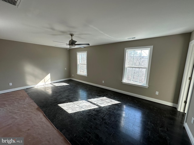 unfurnished room with a healthy amount of sunlight and ceiling fan