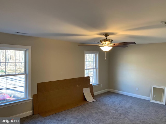 carpeted spare room with ceiling fan