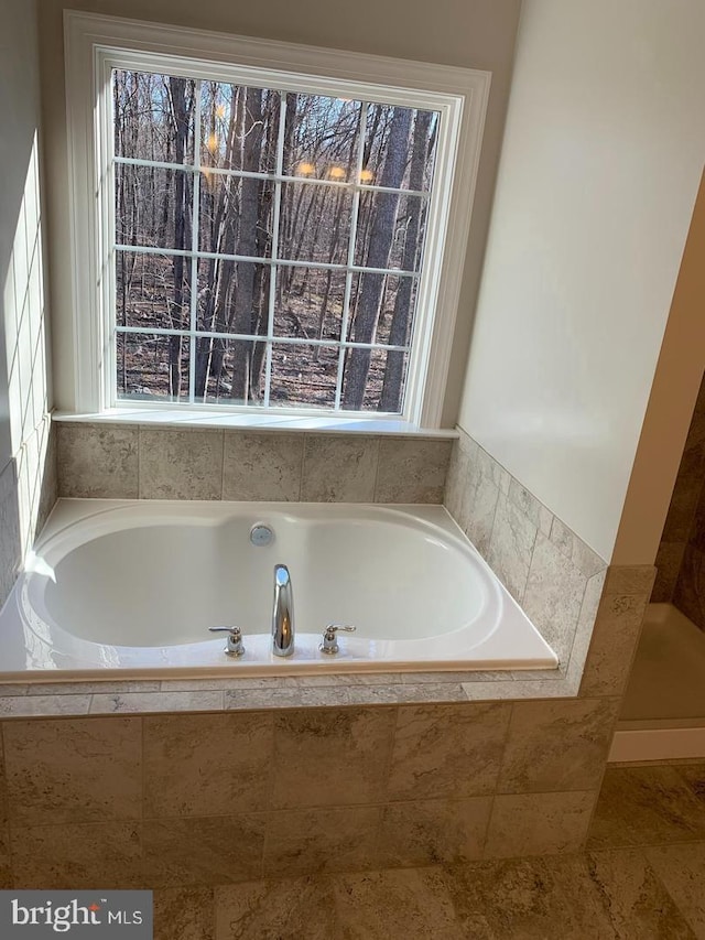 bathroom featuring tiled bath