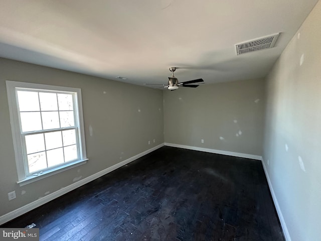 empty room featuring dark hardwood / wood-style flooring and ceiling fan