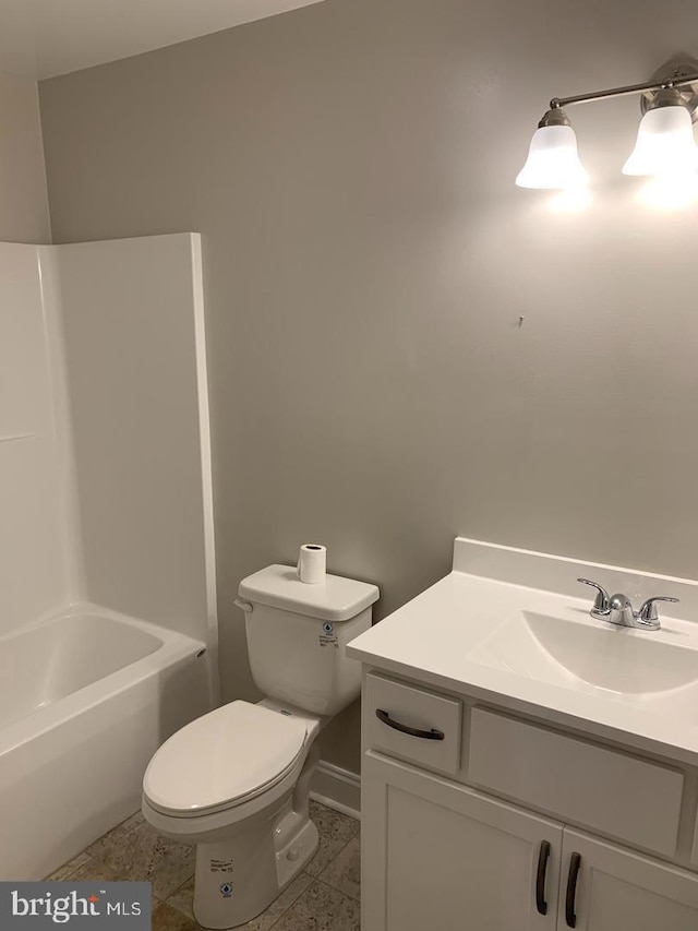 bathroom with vanity, tile patterned flooring, and toilet