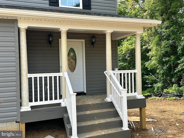 view of exterior entry with a porch