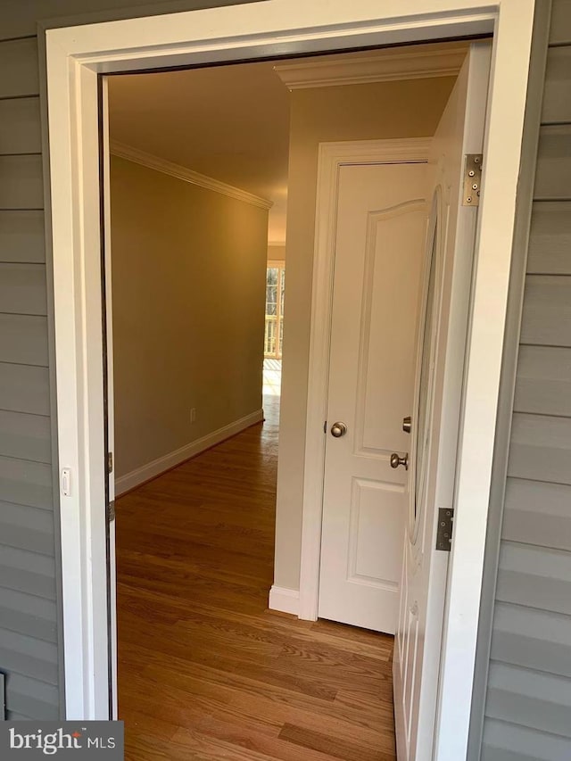 corridor with crown molding and light hardwood / wood-style flooring