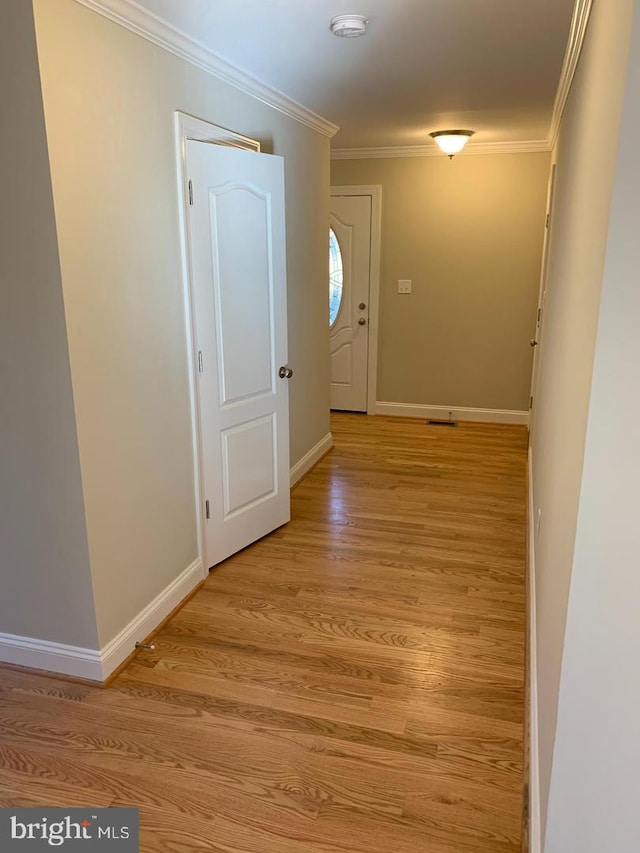 corridor featuring crown molding and light wood-type flooring