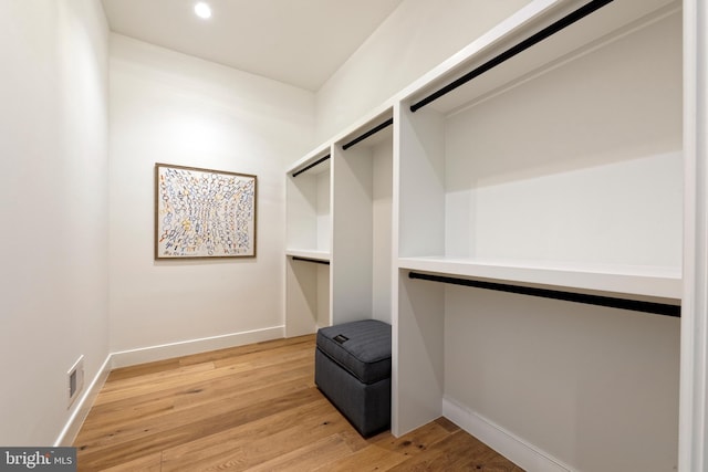 spacious closet with light hardwood / wood-style floors