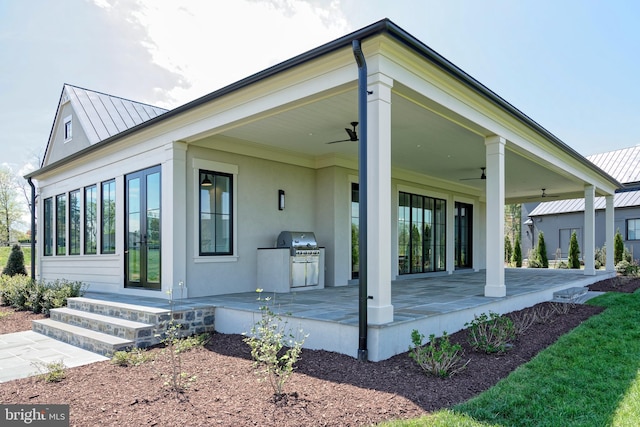 back of property featuring ceiling fan and an outdoor kitchen