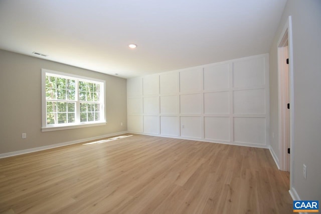 empty room with light hardwood / wood-style flooring