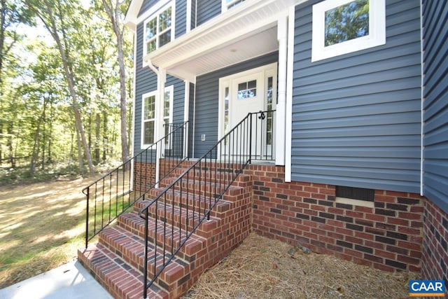 view of exterior entry with covered porch