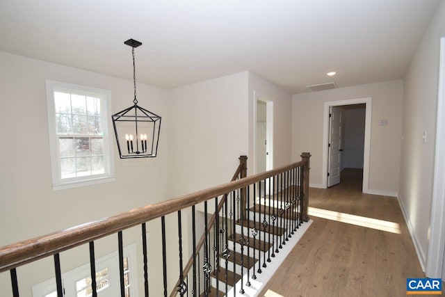 hall featuring a chandelier and dark hardwood / wood-style floors