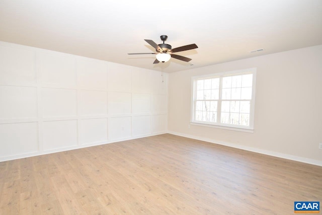 spare room featuring ceiling fan and light hardwood / wood-style flooring