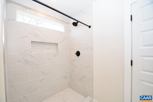 bathroom with tiled shower