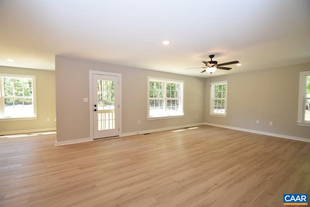 empty room featuring ceiling fan and light hardwood / wood-style flooring