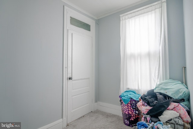 bedroom with light colored carpet and crown molding