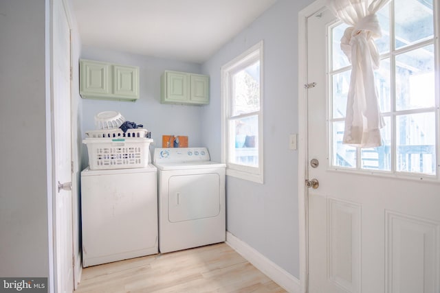 washroom featuring cabinets, independent washer and dryer, and light wood-type flooring