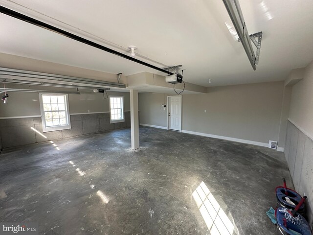 garage with a garage door opener and baseboards