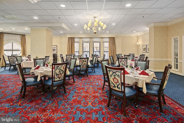 dining room featuring a notable chandelier, carpet floors, and crown molding