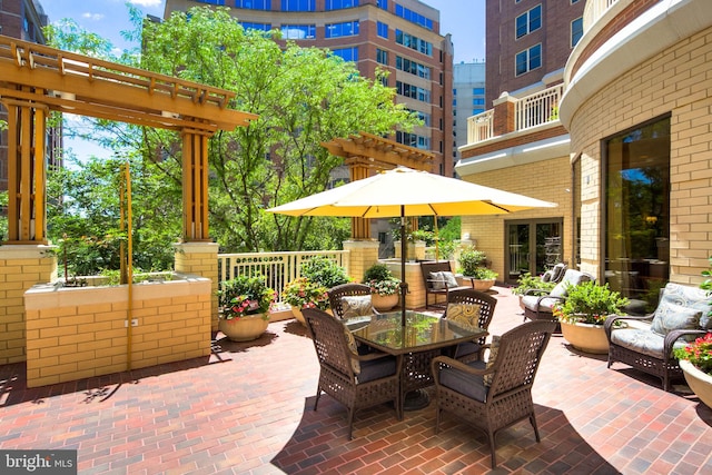 view of patio with outdoor lounge area, a pergola, and a balcony