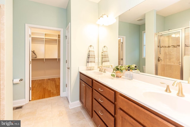 bathroom featuring vanity and an enclosed shower