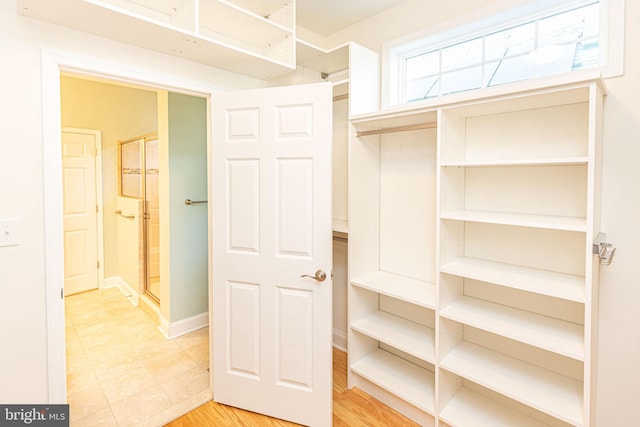 walk in closet featuring light hardwood / wood-style flooring