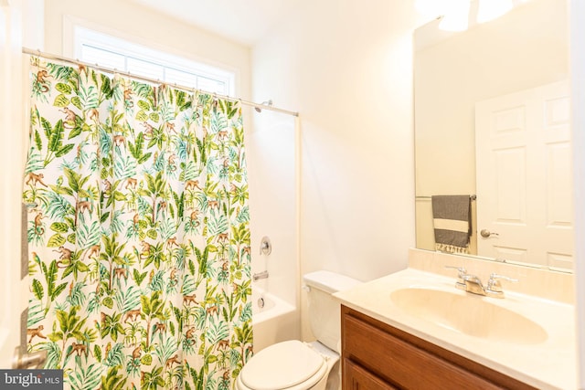 full bathroom featuring shower / bath combo, vanity, and toilet