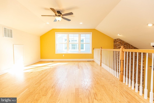 additional living space featuring hardwood / wood-style flooring, ceiling fan, and vaulted ceiling