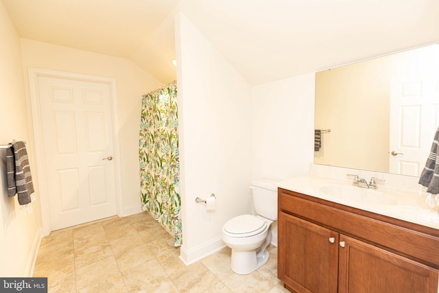 bathroom featuring vanity, lofted ceiling, and toilet