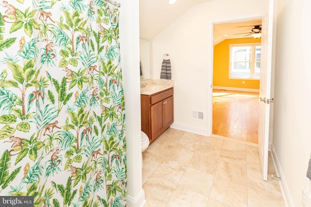 bathroom with vanity, vaulted ceiling, ceiling fan, hardwood / wood-style flooring, and toilet