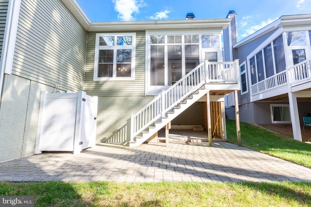 back of house featuring a sunroom and a patio area